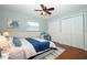 Cozy bedroom features wood floors, white trim and furnishings, and a bright blue accent color at 300 Royal Palm Ct, Longwood, FL 32779