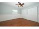 This bedroom features wood floors, a ceiling fan, and white trim and doors at 300 Royal Palm Ct, Longwood, FL 32779