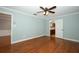 Bright bedroom featuring wood floors and a ceiling fan, with an attached bathroom at 300 Royal Palm Ct, Longwood, FL 32779