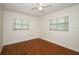 An empty bedroom featuring bright, natural light, wood flooring, and neutral walls at 300 Royal Palm Ct, Longwood, FL 32779