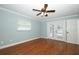 Bright bedroom with hardwood floors, a ceiling fan, and patio doors at 300 Royal Palm Ct, Longwood, FL 32779