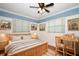 This bedroom features wood floors, natural light, and an eclectic decor at 300 Royal Palm Ct, Longwood, FL 32779