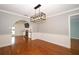 Open dining room with modern light fixture and hardwood floors at 300 Royal Palm Ct, Longwood, FL 32779