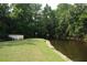 Well-manicured lawn leading to a small dock on the community waterfront at 300 Royal Palm Ct, Longwood, FL 32779