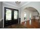Spacious entryway with tile flooring and double doors, leading to the living area with hardwood floors at 300 Royal Palm Ct, Longwood, FL 32779