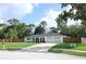 Charming single-story home featuring a well-manicured lawn, a long driveway, and an attached two-car garage at 300 Royal Palm Ct, Longwood, FL 32779