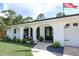 Charming front porch with beautiful archways, potted plants, and seating, inviting relaxation and curb appeal at 300 Royal Palm Ct, Longwood, FL 32779