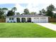 Charming single-story home with a well-manicured lawn and attached three-car garage at 300 Royal Palm Ct, Longwood, FL 32779