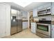 Modern kitchen with stainless steel appliances and light blue cabinetry at 300 Royal Palm Ct, Longwood, FL 32779
