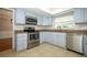 Well-equipped kitchen with stainless steel appliances and light blue cabinetry at 300 Royal Palm Ct, Longwood, FL 32779