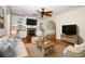 Comfortable living room featuring hardwood floors, a decorative fireplace, and built-in bookshelves at 300 Royal Palm Ct, Longwood, FL 32779