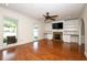 Bright living room with hardwood floors, built-in shelving, and a cozy fireplace at 300 Royal Palm Ct, Longwood, FL 32779