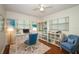 Bright office space featuring wood floors, natural light, white trim, and coastal decor at 300 Royal Palm Ct, Longwood, FL 32779