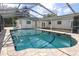 This pool features a brick surround, screened enclosure, and is attached to the home's backyard patio at 300 Royal Palm Ct, Longwood, FL 32779