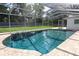 A pool with a screened enclosure is surrounded by a brick patio and green grass at 300 Royal Palm Ct, Longwood, FL 32779