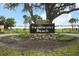 The Sweetwater Beach community entrance sign surrounded by landscaping at 300 Royal Palm Ct, Longwood, FL 32779