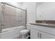 Bathroom featuring a shower and tub combo with glass doors, single sink with vanity, and tile floors at 3123 Camden Way, Davenport, FL 33837