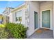 Close-up of the home's entrance with a stylish door, stone accents, and manicured shrubs at 3123 Camden Way, Davenport, FL 33837