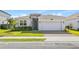 Charming single-story home with a stone facade, a two-car garage, and a well-manicured lawn at 3123 Camden Way, Davenport, FL 33837
