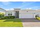 Well-maintained single-Gathering home featuring a two-car garage and lush green landscaping at 3123 Camden Way, Davenport, FL 33837