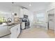 Well-lit kitchen with white cabinets, modern appliances, and a cozy breakfast nook at 3123 Camden Way, Davenport, FL 33837