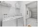 Functional laundry area with washer, dryer, storage shelves and access to the garage at 3123 Camden Way, Davenport, FL 33837