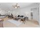 Open-concept living room with tile floors, ceiling fan, modern furniture, and view to kitchen and dining areas at 3123 Camden Way, Davenport, FL 33837