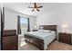 The main bedroom features a large window, ceiling fan, neutral carpet, and a dark wood bedroom set at 3123 Camden Way, Davenport, FL 33837