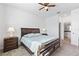The main bedroom features neutral carpet, ensuite bathroom, a large window, and a dark wood bedroom set at 3123 Camden Way, Davenport, FL 33837