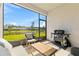 Enjoy outdoor living on this patio with seating and a grill, overlooking the water at 3123 Camden Way, Davenport, FL 33837
