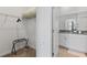 A walk-in closet with shelving and a view to an ensuite bathroom with double sinks and white cabinets at 3123 Camden Way, Davenport, FL 33837