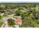 Aerial view of neighborhood with mature trees, houses, and a pond at 3511 Superior Ct, Orlando, FL 32810