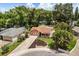 Aerial view of a cozy home nestled among mature trees in a quiet residential neighborhood at 3511 Superior Ct, Orlando, FL 32810