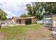 A wide backyard with grass area, sheds, and white picket fence at 3511 Superior Ct, Orlando, FL 32810