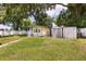 Spacious backyard features multiple sheds and a white picket fence at 3511 Superior Ct, Orlando, FL 32810