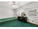 Bedroom with black dresser, green carpet and two windows at 3511 Superior Ct, Orlando, FL 32810