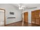 Bright bedroom featuring a ceiling fan, hardwood floors, and closet with sliding doors at 3511 Superior Ct, Orlando, FL 32810