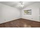 Bright and airy bedroom with hardwood floors, a ceiling fan, and a large window at 3511 Superior Ct, Orlando, FL 32810