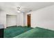 Bedroom with green carpet and open closet at 3511 Superior Ct, Orlando, FL 32810