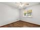 Bedroom featuring a bright window, wood floors, and neutral walls at 3511 Superior Ct, Orlando, FL 32810