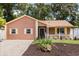 Charming single story home featuring a fenced yard, mature trees, and a welcoming front porch at 3511 Superior Ct, Orlando, FL 32810