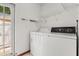 Bright laundry area equipped with a modern washer and dryer set at 3511 Superior Ct, Orlando, FL 32810