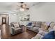 Spacious living room featuring hardwood floors, a ceiling fan, and comfortable gray seating at 3511 Superior Ct, Orlando, FL 32810