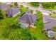 Aerial view of a home with a screened pool, well-manicured lawn, and lush landscaping in a suburban setting at 3753 Heirloom Rose Pl, Oviedo, FL 32766