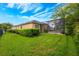Spacious backyard with lush green lawn, screened-in pool, hedges, and well-manicured landscaping for outdoor enjoyment at 3753 Heirloom Rose Pl, Oviedo, FL 32766