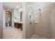 Bright bathroom featuring a walk-in shower, vanity, and view into other rooms at 3753 Heirloom Rose Pl, Oviedo, FL 32766