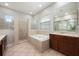 Bathroom features a soaking tub, walk-in shower, and double vanity with dark wood cabinets at 3753 Heirloom Rose Pl, Oviedo, FL 32766