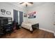 Bedroom with wood floors, a single bed, dark curtains, and a ceiling fan at 3753 Heirloom Rose Pl, Oviedo, FL 32766