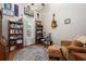Charming room with hardwood floors, bookshelves, a window, and a cozy chair at 3753 Heirloom Rose Pl, Oviedo, FL 32766