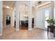 Grand foyer with arched doorways, tile floors, and view to dining room at 3753 Heirloom Rose Pl, Oviedo, FL 32766